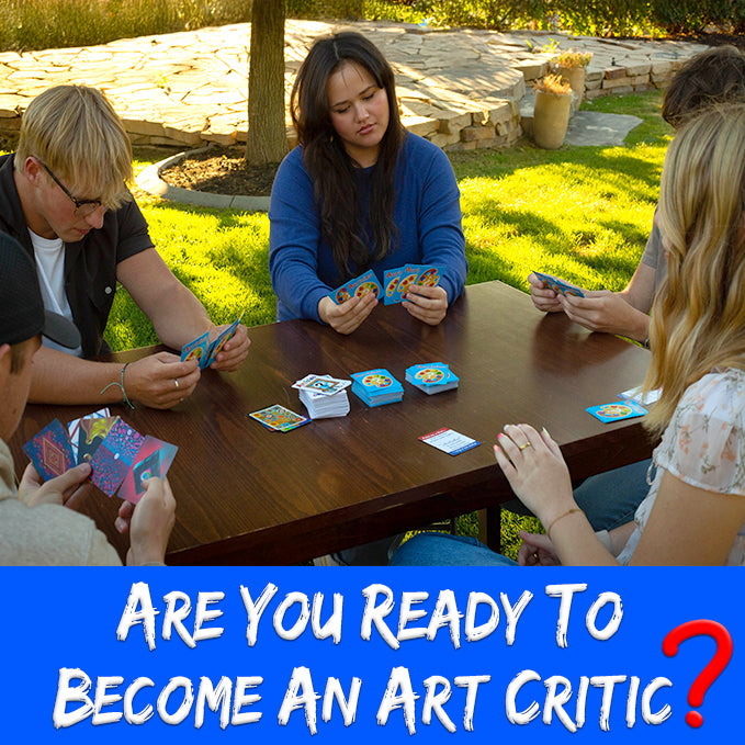 People playing group game Artisimo outside on wooden table